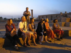 Baby boomers listen to an archaeologist talk about the ruins at Kom Ombo in Egypt